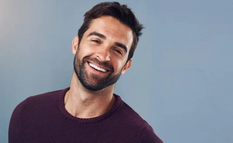 Happy, man and portrait with mockup for confidence, pride and positive attitude isolated in studio. Smile, male person or model with commercial space for pride and optimism with gray background